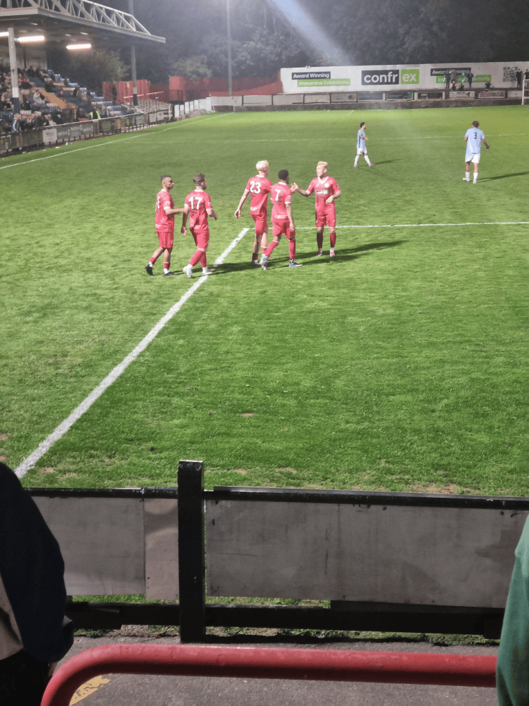 Wings player congratulating Kaan Bennett for his exceptional assit